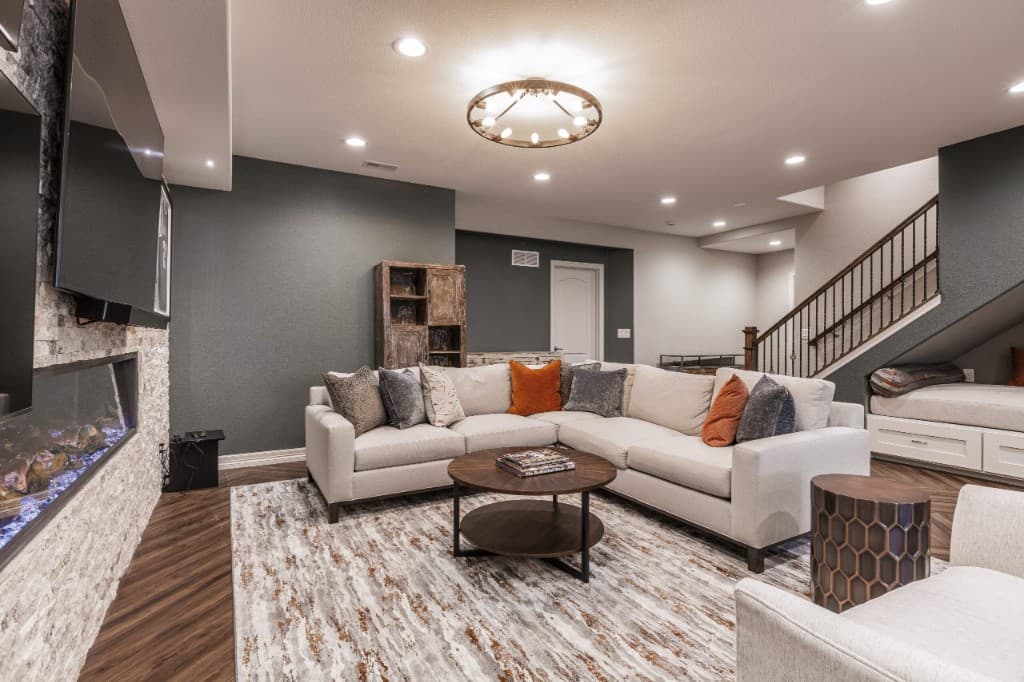 Finished basement living space with modern seating and fireplace
